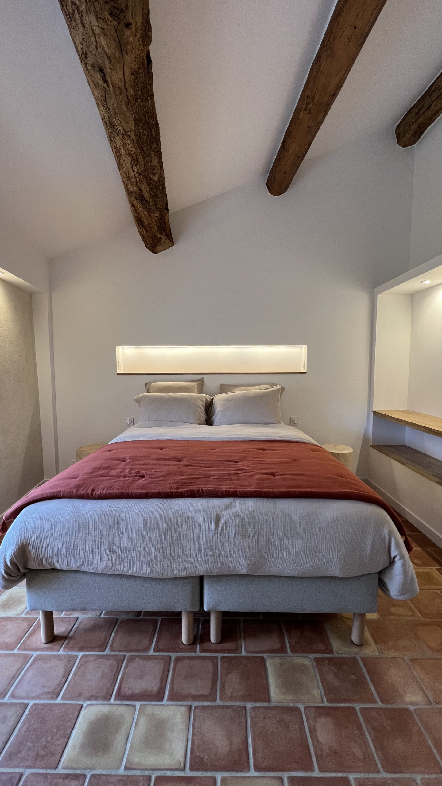 Texte alternatif Chambre double du gîte La Grange avec poutres apparentes et sol en tomettes